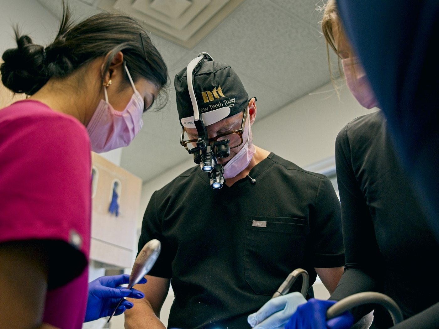 Dr. Michael Webster in implant surgery, with his assistant