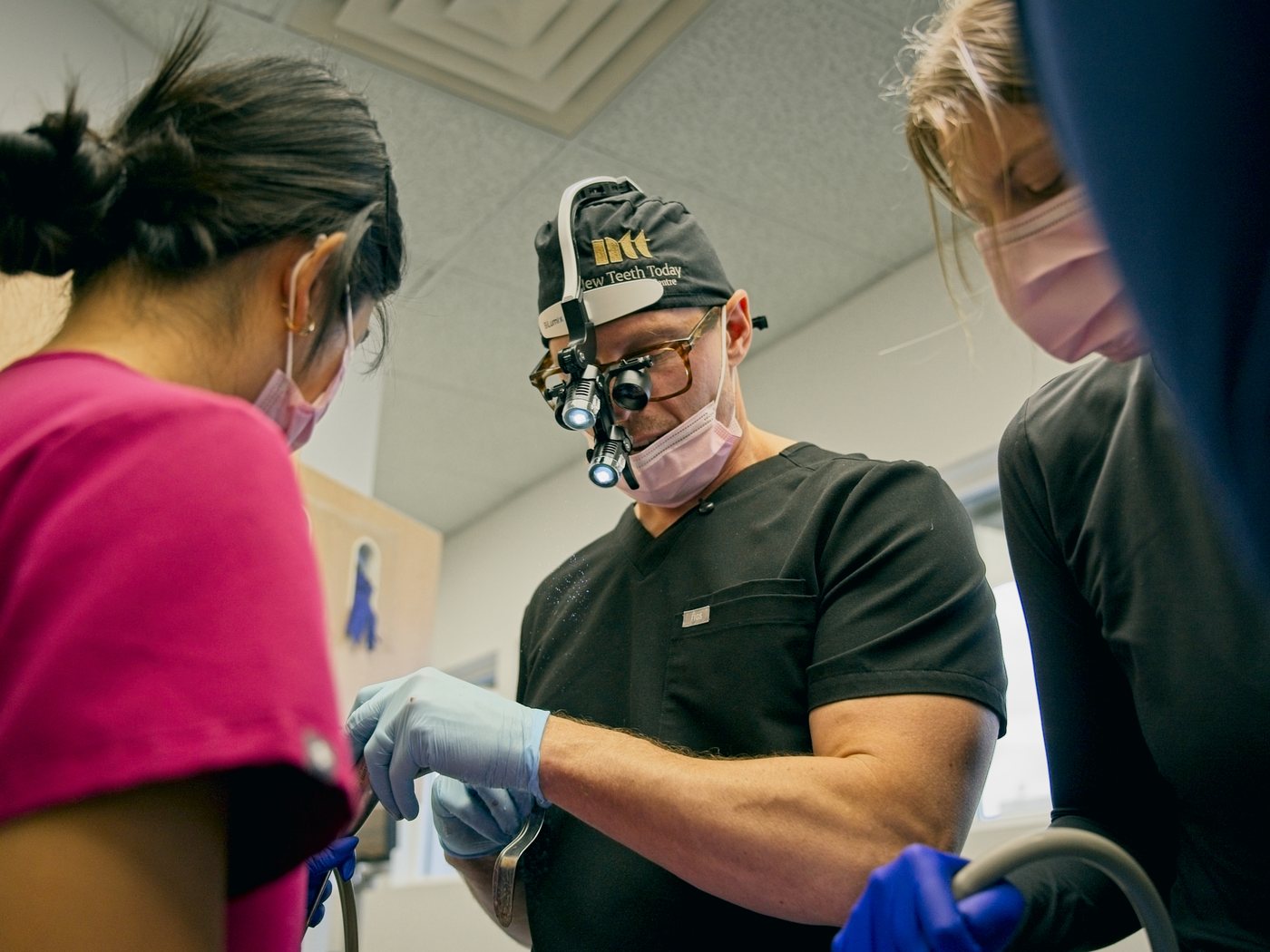 Dr. Michael Webster in implant surgery, with his assistant