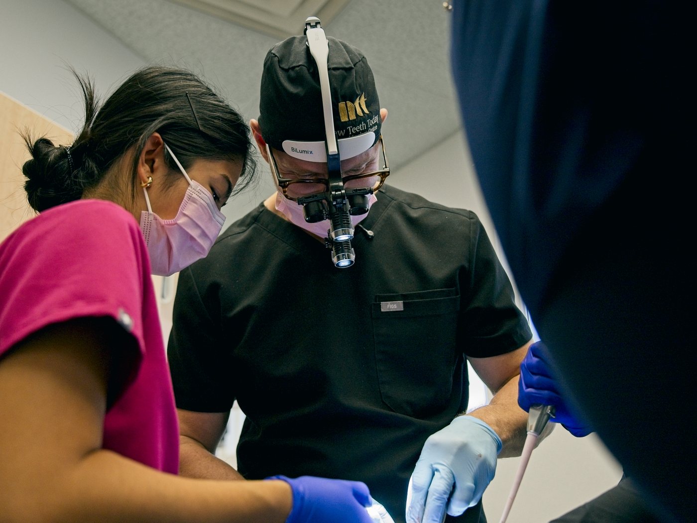 Dr. Michael Webster in implant surgery, with his assistant